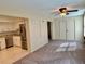 Open-concept room with ceiling fan, carpet, sliding closet and kitchen area at 2070 World Parkway Blvd # 36, Clearwater, FL 33763