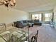 Inviting living room featuring a comfortable sofa, glass coffee table, and dining area at 2070 World Parkway Blvd # 36, Clearwater, FL 33763