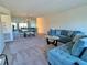 Spacious living room featuring a plush sofa, a large mirror, and an elegant dining set at 2070 World Parkway Blvd # 36, Clearwater, FL 33763