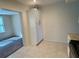 View of the pantry closet in the kitchen with tile flooring and views into an adjacent carpeted room at 2070 World Parkway Blvd # 36, Clearwater, FL 33763
