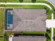 Aerial shot capturing the backyard with screened-in pool, roof, and community landscaping at 21837 Briske Morning Ave, Land O Lakes, FL 34637