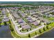Expansive aerial showcasing a residential area with tree-lined streets and homes surrounding a beautiful, scenic lake at 21837 Briske Morning Ave, Land O Lakes, FL 34637