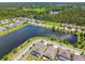 Panoramic aerial capturing homes near a serene lake and lush green spaces, blending residential living with nature at 21837 Briske Morning Ave, Land O Lakes, FL 34637