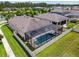 Aerial view of a private pool, hot tub, and screened-in enclosure, perfect for outdoor relaxation at 21837 Briske Morning Ave, Land O Lakes, FL 34637