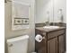 Bathroom featuring a wooden vanity with granite top and a white toilet with matching towel at 21837 Briske Morning Ave, Land O Lakes, FL 34637
