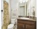 A well-lit bathroom featuring a wooden vanity with granite top and a shower and tub combo at 21837 Briske Morning Ave, Land O Lakes, FL 34637