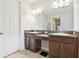 Bathroom featuring double sinks with a vanity area, granite countertops, and ample cabinet space at 21837 Briske Morning Ave, Land O Lakes, FL 34637