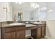 Bathroom featuring dual sinks, granite countertops, and a walk-in shower at 21837 Briske Morning Ave, Land O Lakes, FL 34637