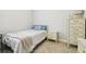 Bedroom with herringbone wood floors, a twin bed, and white bedside table with decor at 21837 Briske Morning Ave, Land O Lakes, FL 34637