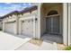 Close up of a three-car garage and arched front entryway with double doors at 21837 Briske Morning Ave, Land O Lakes, FL 34637