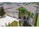 A beautiful house with three garage doors and mature palm trees, creating a tropical appeal at 21837 Briske Morning Ave, Land O Lakes, FL 34637