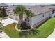 A home exterior shows manicured landscaping, palm trees and three car garage at 21837 Briske Morning Ave, Land O Lakes, FL 34637