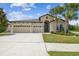 Charming single-Gathering home with a three-car garage and lush, tropical landscaping at 21837 Briske Morning Ave, Land O Lakes, FL 34637