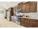 Spacious kitchen features stainless steel appliances, granite countertops, and dark wood cabinetry at 21837 Briske Morning Ave, Land O Lakes, FL 34637