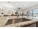 Close up shot of kitchen island with granite countertops and stainless steel sink at 21837 Briske Morning Ave, Land O Lakes, FL 34637