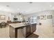 Open kitchen with granite island, stainless steel appliances, and tile flooring at 21837 Briske Morning Ave, Land O Lakes, FL 34637