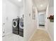 Convenient laundry room with washer and dryer, located near the bedroom and hallway at 21837 Briske Morning Ave, Land O Lakes, FL 34637