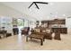 Open-concept living room with tile flooring, adjacent to the modern kitchen at 21837 Briske Morning Ave, Land O Lakes, FL 34637