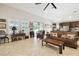 Bright living room with vaulted ceilings, tile floors, and slider doors to outdoor pool at 21837 Briske Morning Ave, Land O Lakes, FL 34637