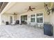 Covered patio with ceiling fans, stone flooring, and outdoor seating at 21837 Briske Morning Ave, Land O Lakes, FL 34637