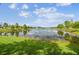 A calming view of the pond, with trees and homes surrounding the water at 21837 Briske Morning Ave, Land O Lakes, FL 34637