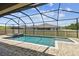 Inviting in-ground pool with screened enclosure and paved deck at 21837 Briske Morning Ave, Land O Lakes, FL 34637