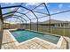 Refreshing pool in screened enclosure with stone pavers at 21837 Briske Morning Ave, Land O Lakes, FL 34637