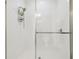 Bright shower featuring white tiling and a glass door for a clean and modern design at 21837 Briske Morning Ave, Land O Lakes, FL 34637