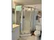 Bathroom with glass shower stall, white tile, and updated fixtures at 25050 Sandhill Blvd # 8B1, Punta Gorda, FL 33983