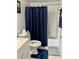Bathroom with a toilet, vanity and shower with blue curtain at 25050 Sandhill Blvd # 8B1, Punta Gorda, FL 33983
