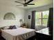 Bedroom with neutral tones, a comfortable bed, dresser, and a window at 25050 Sandhill Blvd # 8B1, Punta Gorda, FL 33983