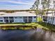 Waterfront condo featuring a screened patio with gorgeous views of the pond and lush landscaping at 25050 Sandhill Blvd # 8B1, Punta Gorda, FL 33983