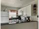 Cozy kitchen featuring bright cabinetry, appliances, and an open view of the dining area at 25050 Sandhill Blvd # 8B1, Punta Gorda, FL 33983