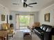 Inviting living area with neutral tones, ceiling fan, and sliding doors leading to the lanai at 25050 Sandhill Blvd # 8B1, Punta Gorda, FL 33983