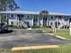 Exterior of condo with convenient parking, well-kept lawns, and inviting stairways to upper units at 25050 Sandhill Blvd # 8B1, Punta Gorda, FL 33983