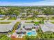 An aerial view showcases the home, pool, shed, solar panels, and beautiful landscaping at 2581 61St S Ave, St Petersburg, FL 33712