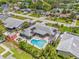 Stunning aerial view of backyard featuring a kidney-shaped pool, sunny lounge area, privacy fence, and a detached shed at 2581 61St S Ave, St Petersburg, FL 33712