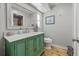 Bathroom boasts a green vanity with white countertop and unique wall mirror at 2581 61St S Ave, St Petersburg, FL 33712