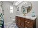 Bathroom features a modern vanity with gold hardware, patterned tile flooring, and a shower at 2581 61St S Ave, St Petersburg, FL 33712