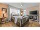 Bedroom with a dark metal bed frame, wood floors, and modern decor at 2581 61St S Ave, St Petersburg, FL 33712