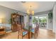 Bright dining room features glass table, modern light fixture and seamless access to the outdoor patio and pool at 2581 61St S Ave, St Petersburg, FL 33712