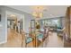 Bright dining area featuring hardwood floors, glass table, flows to the living room creating an open-concept layout at 2581 61St S Ave, St Petersburg, FL 33712