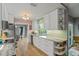 Bright kitchen features white cabinetry, stainless appliances, and hardwood flooring at 2581 61St S Ave, St Petersburg, FL 33712