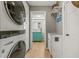 Bright laundry room featuring a stackable washer/dryer and a view to the bathroom at 2581 61St S Ave, St Petersburg, FL 33712