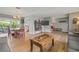 Open-concept living area featuring hardwood floors, modern furnishings, and ample natural light with views to dining area at 2581 61St S Ave, St Petersburg, FL 33712