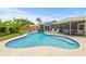 Beautiful kidney-shaped pool with lounge chairs, patio and a lush garden create a private backyard retreat at 2581 61St S Ave, St Petersburg, FL 33712