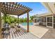 Inviting backyard features a pergola, pool, screened in porch and patio seating at 2581 61St S Ave, St Petersburg, FL 33712