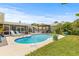 Backyard pool area with lounge chairs, lush landscaping, and a pergola at 2581 61St S Ave, St Petersburg, FL 33712