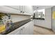 Bathroom featuring granite countertops, double sinks, and white cabinetry at 3035 Countryside Blvd # 16B, Clearwater, FL 33761