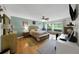 A cozy bedroom with wood floors, a sitting area, and a queen bed at 3035 Countryside Blvd # 16B, Clearwater, FL 33761